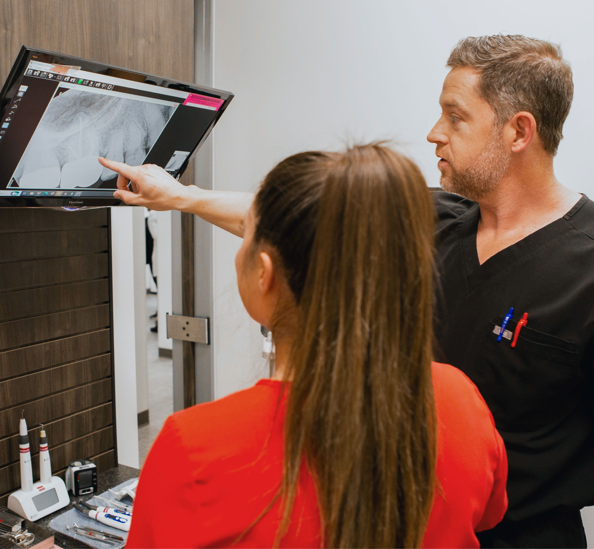 EndoConnect clinician reviewing a dental radiograph with a team member in a clinical setting