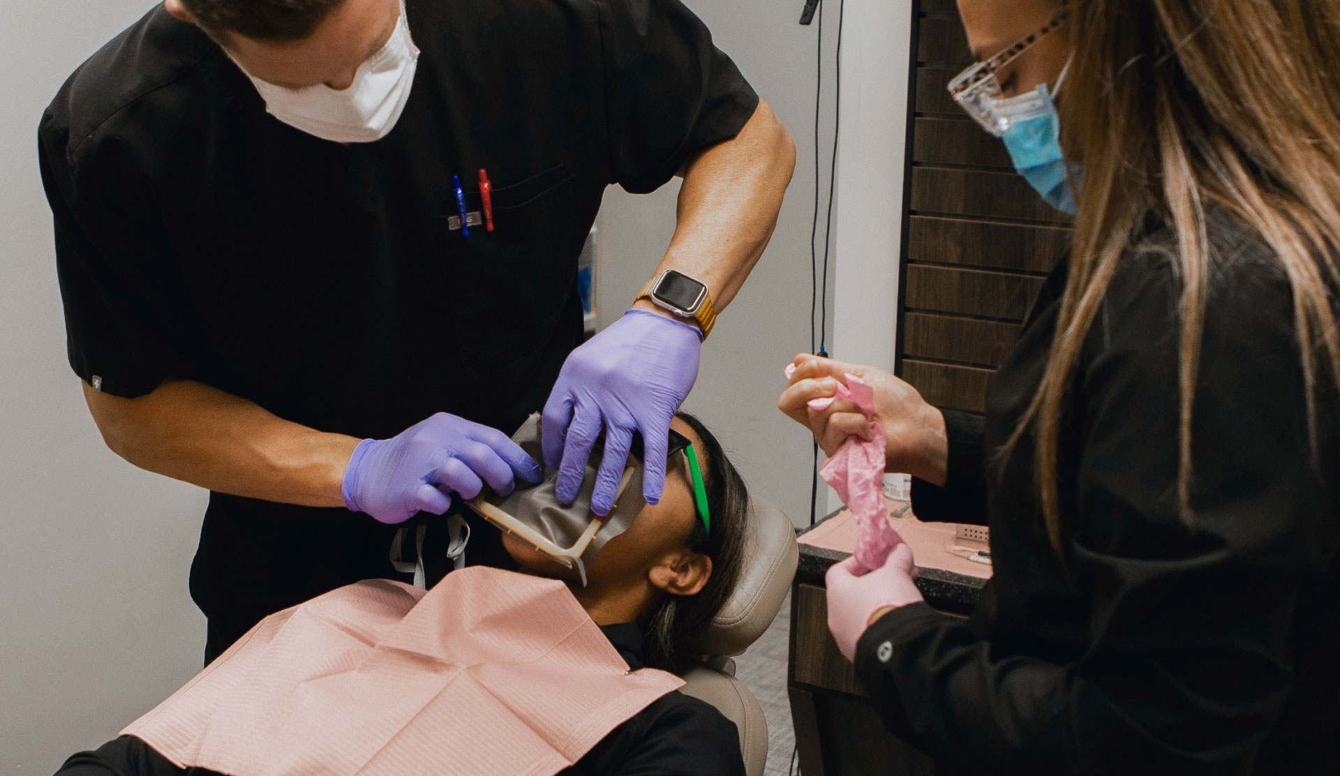 Dr. Middleton and assistant working with patient