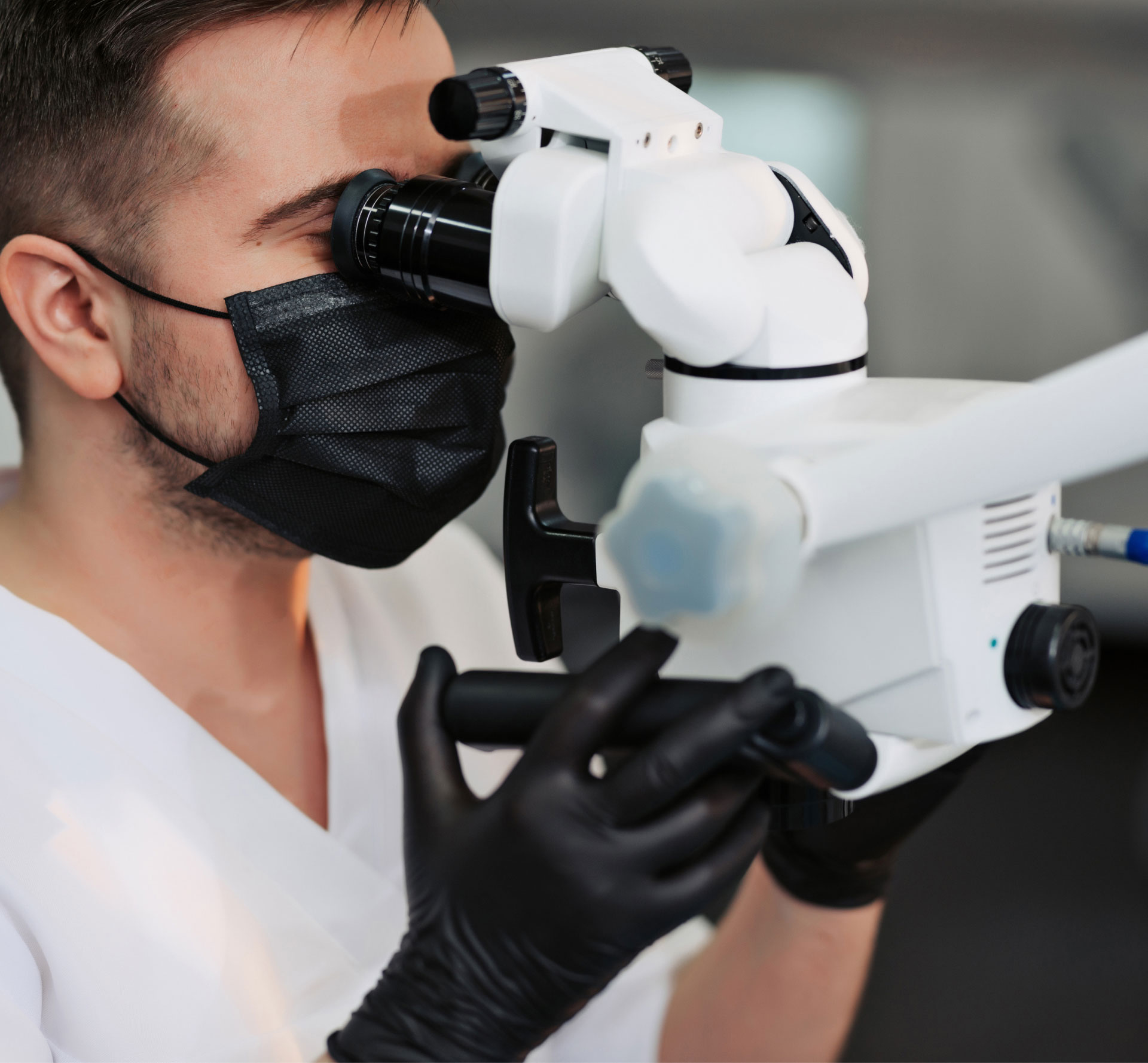 dentist looking through dental microscope